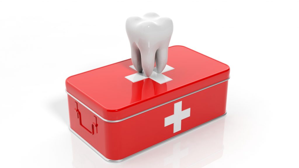 A tooth placed inside a first aid box, symbolizing dental care and emergency dental treatment.